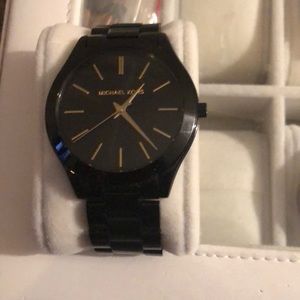 Black and gold Michael Kors woman’s watch